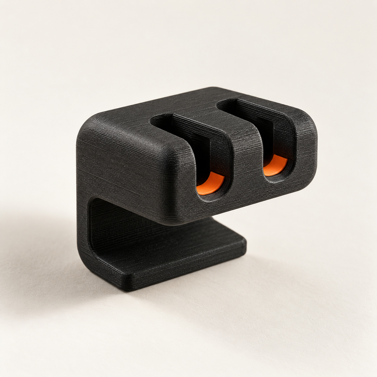 Black and orange 3D-printed cable catch prototype